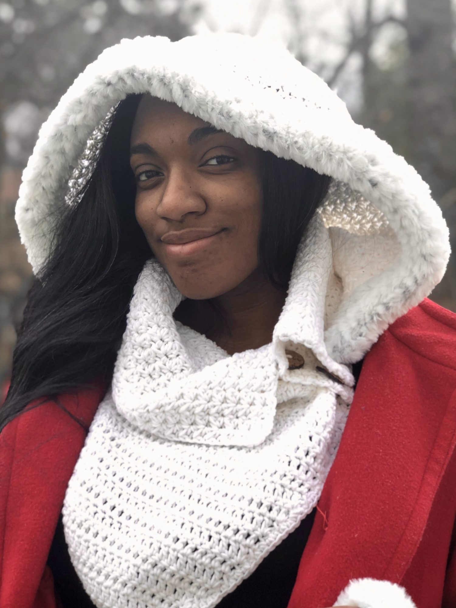 The Ashley Hooded Cowl offers subtle texture stitches, a button closure, and triangle front and back for added warmth. The shaped hood is removable.
