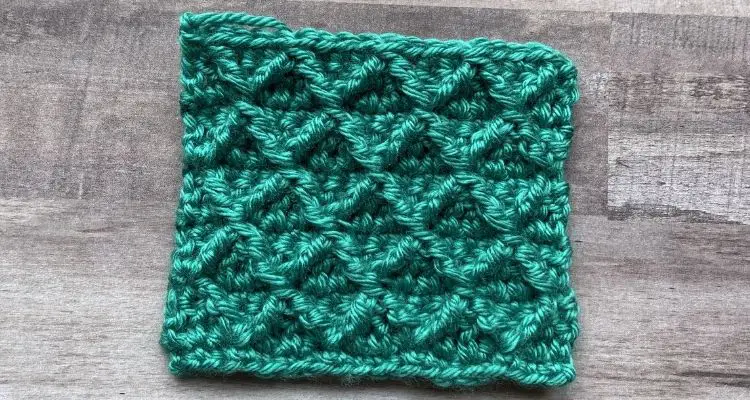 An image of the diamond trellis stitch created by connecting groups of front post treble stitches.